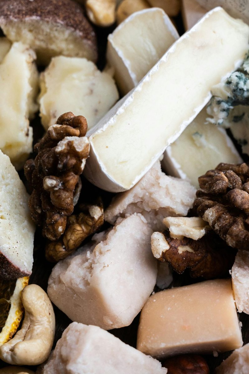 Delicious assortment of cheeses and nuts, perfect for a gourmet snack platter.