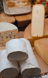 A variety of French cheeses including Bûche du Poitou, showcasing texture and variety.