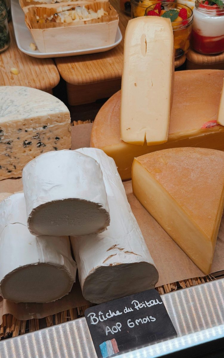 A variety of French cheeses including Bûche du Poitou, showcasing texture and variety.